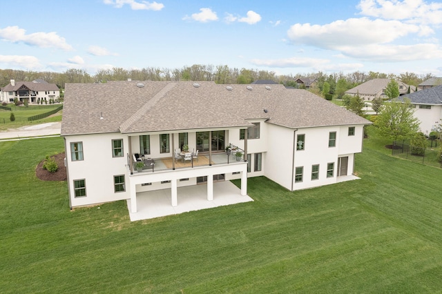 back of house with stucco siding, a shingled roof, and a patio area