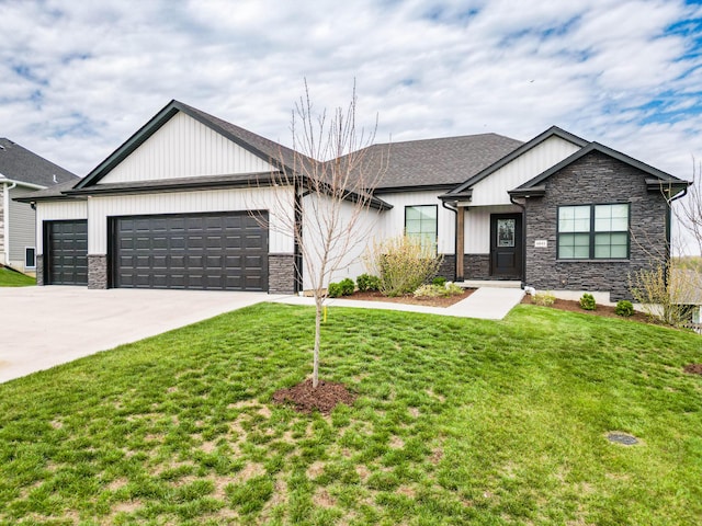view of front of property with a front yard, a garage, driveway, stone siding, and board and batten siding