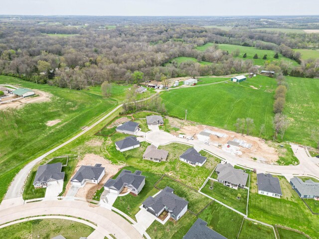 aerial view featuring a view of trees and a residential view