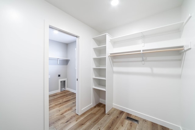 spacious closet with wood finished floors and visible vents