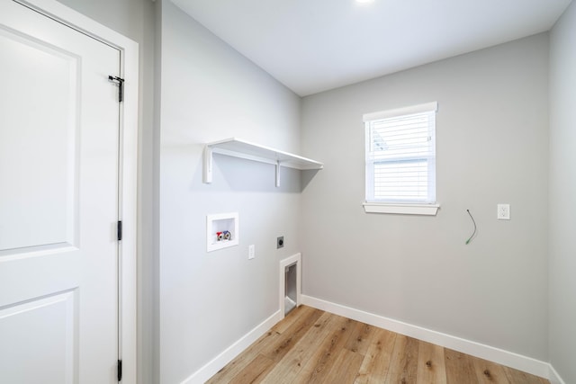 washroom with light wood finished floors, hookup for an electric dryer, laundry area, hookup for a washing machine, and baseboards