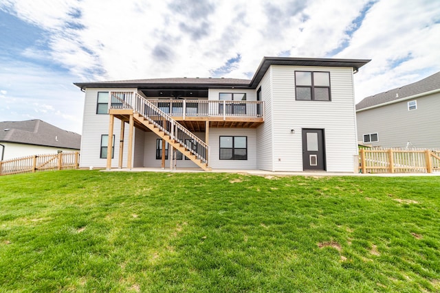 back of property featuring a patio, a wooden deck, a yard, a fenced backyard, and stairs