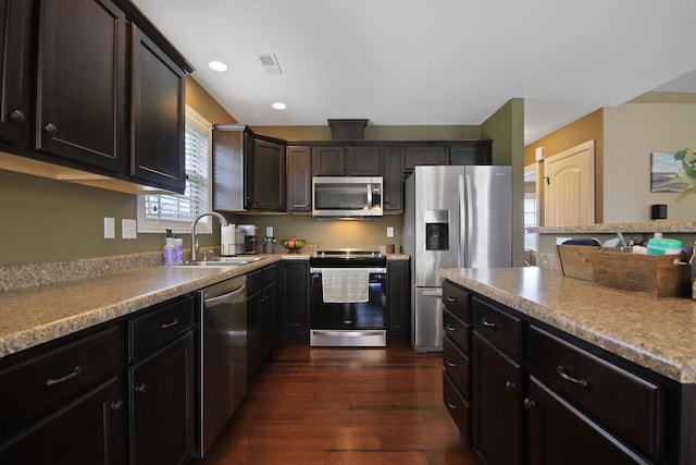 kitchen with recessed lighting, appliances with stainless steel finishes, dark wood-style flooring, a sink, and visible vents