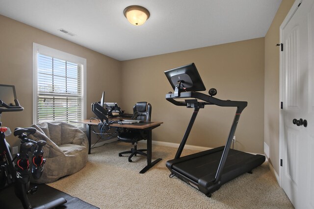workout area featuring baseboards, visible vents, and carpet floors