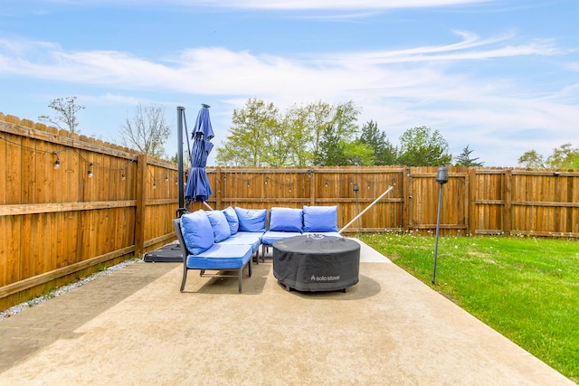 view of patio featuring a gate, a fenced backyard, and an outdoor living space with a fire pit