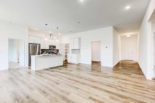 6575 Gateway Arch Way, Ashland, MO 65010 - kitchen with appliances with stainless steel finishes, open floor plan, recessed lighting, an island with sink, and white cabinets