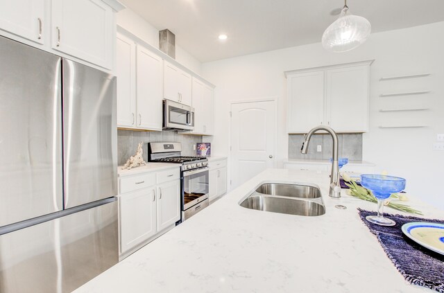 6575 Gateway Arch Way, Ashland, MO 65010 - kitchen with appliances with stainless steel finishes, a sink, tasteful backsplash, white cabinetry, and recessed lighting