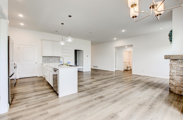 6575 Gateway Arch Way, Ashland, MO 65010 - kitchen featuring dishwasher, light countertops, a sink, a chandelier, and light wood-type flooring