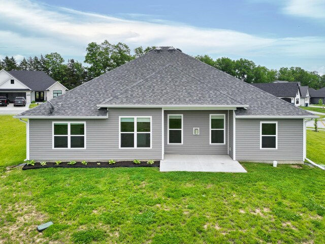 6575 Gateway Arch Way, Ashland, MO 65010 - rear view of house featuring a shingled roof, a patio area, and a lawn