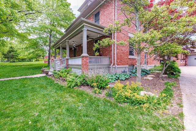 403 Westmount Ave, Columbia, MO 65203 - view of side of home featuring covered porch, a ceiling fan, brick siding, a yard, and driveway