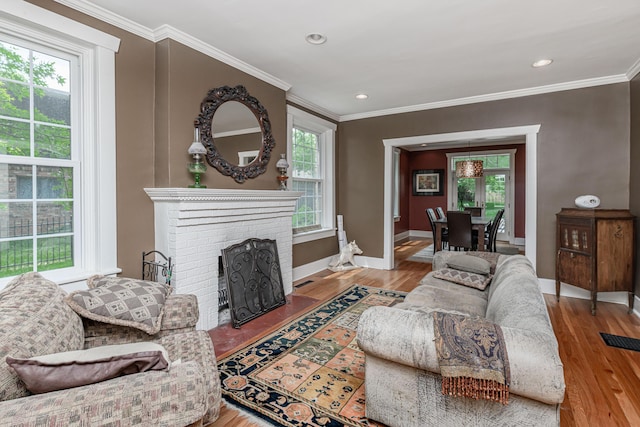403 Westmount Ave, Columbia, MO 65203 - living room with healthy amount of natural light, ornamental molding, baseboards, wood finished floors, and a brick fireplace