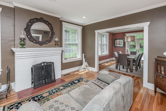 403 Westmount Ave, Columbia, MO 65203 - living room with ornamental molding, baseboards, plenty of natural light, wood finished floors, and a brick fireplace
