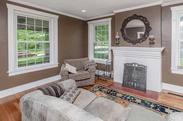 403 Westmount Ave, Columbia, MO 65203 - living room featuring wood finished floors, baseboards, crown molding, a brick fireplace, and recessed lighting