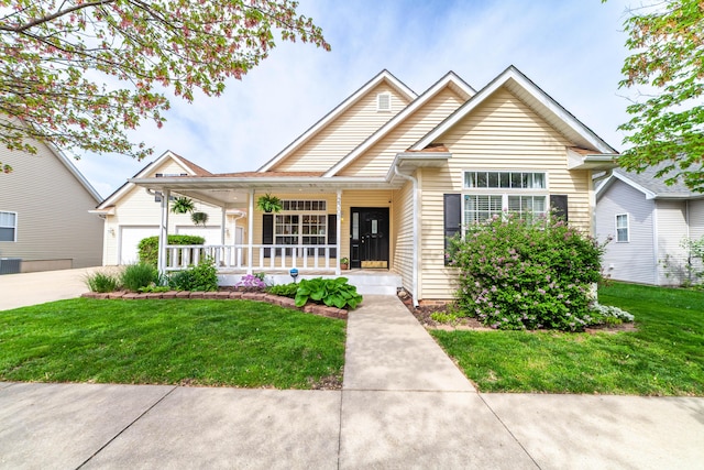 view of front of home with a porch, an attached garage, concrete driveway, and a front lawn