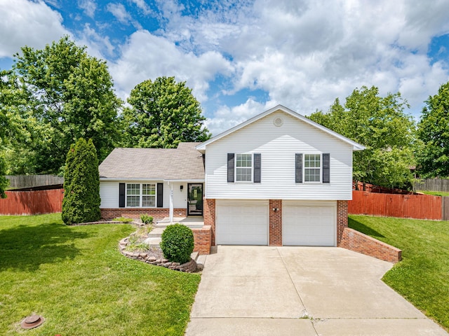 4983 N Montgomery Dr, Columbia, MO 65202 - split level home with brick siding, concrete driveway, and a garage