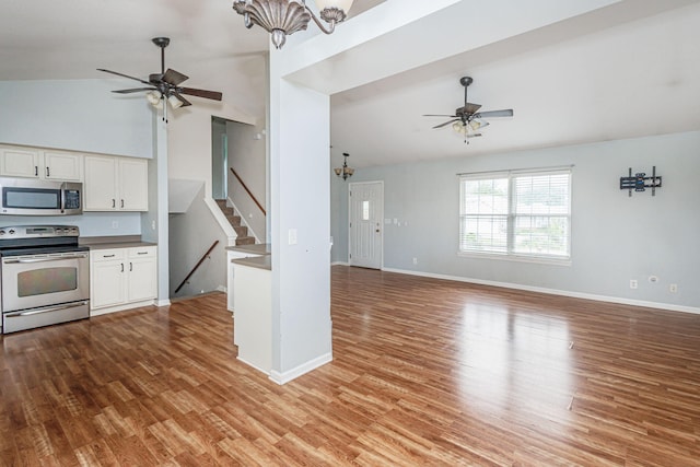 4983 N Montgomery Dr, Columbia, MO 65202 - kitchen featuring appliances with stainless steel finishes, ceiling fan, a chandelier, white cabinets, and wood finished floors