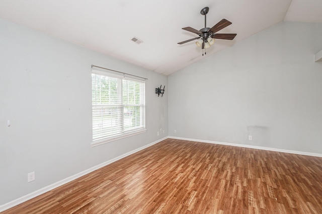 4983 N Montgomery Dr, Columbia, MO 65202 - spare room featuring vaulted ceiling, wood finished floors, a ceiling fan, and baseboards