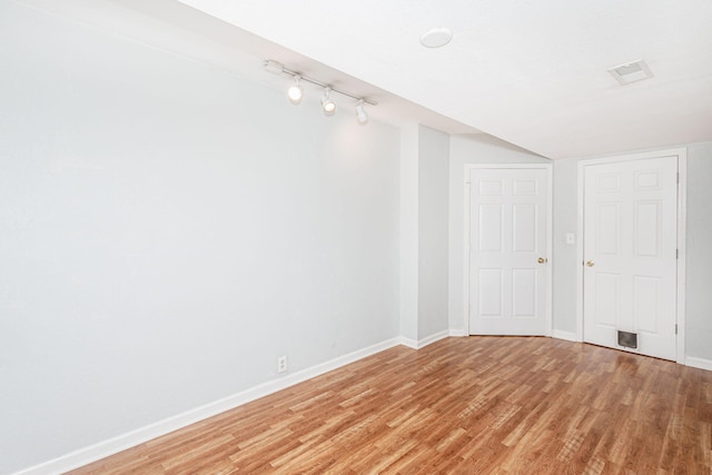 4983 N Montgomery Dr, Columbia, MO 65202 - spare room with baseboards, light wood finished floors, and rail lighting