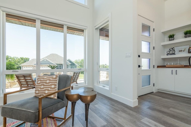 entryway with light wood-style flooring and baseboards