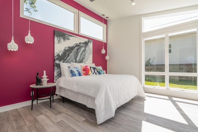 bedroom featuring wood finished floors and recessed lighting