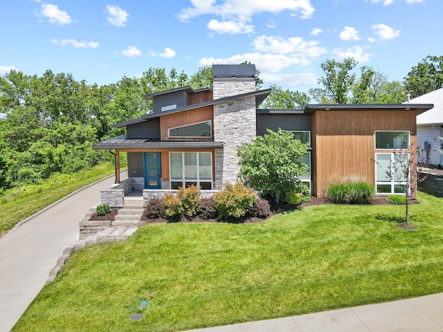 424 Angels Rest Way, Columbia, MO 65203 - contemporary home featuring stone siding, a front lawn, and a chimney