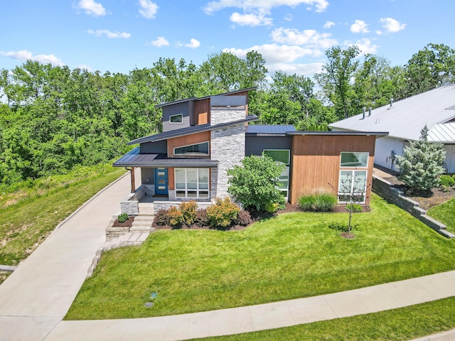 424 Angels Rest Way, Columbia, MO 65203 - view of front of house featuring stone siding, covered porch, a front yard, and metal roof