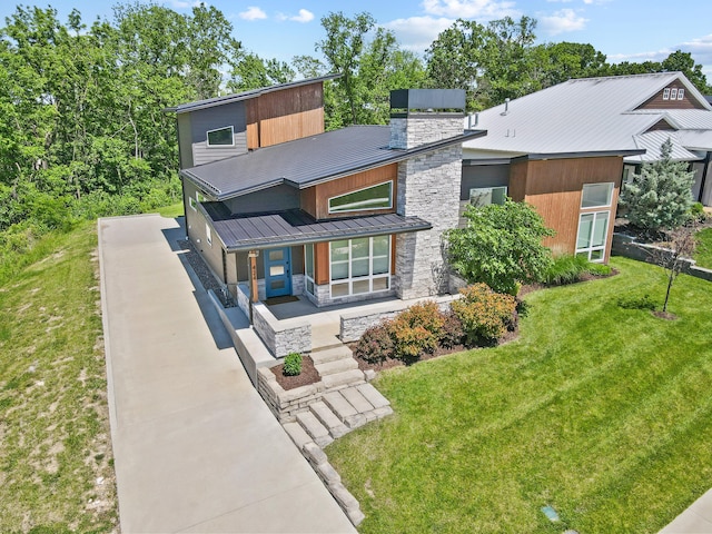 424 Angels Rest Way, Columbia, MO 65203 - view of front of property featuring stone siding, concrete driveway, a front lawn, and a porch