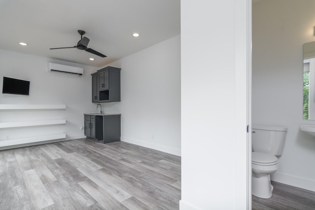 424 Angels Rest Way, Columbia, MO 65203 - unfurnished living room with an AC wall unit, a ceiling fan, light wood-style floors, recessed lighting, and baseboards