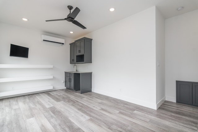424 Angels Rest Way, Columbia, MO 65203 - unfurnished living room with a wall mounted AC, a ceiling fan, light wood-style flooring, recessed lighting, and a sink