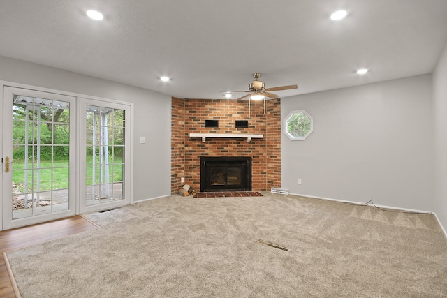 1419 Rosebud St, Mexico, MO 65265 - unfurnished living room with a ceiling fan, recessed lighting, a brick fireplace, and visible vents