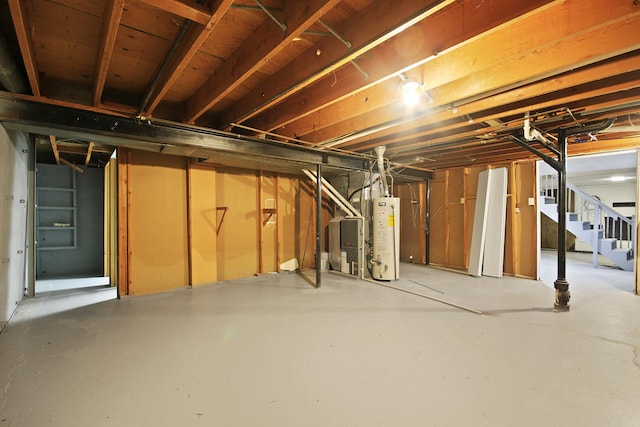 1419 Rosebud St, Mexico, MO 65265 - unfinished below grade area with stairway, heating unit, and gas water heater