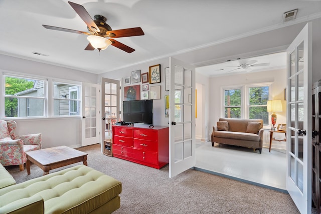 living room with a ceiling fan, visible vents, and french doors