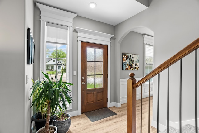 foyer entrance featuring stairs and light wood-style flooring