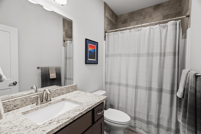 bathroom featuring toilet, curtained shower, and vanity