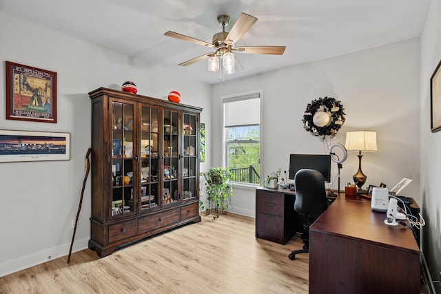 office with light wood-style floors, baseboards, and ceiling fan