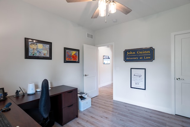 office area featuring baseboards, ceiling fan, light wood-style flooring, and visible vents