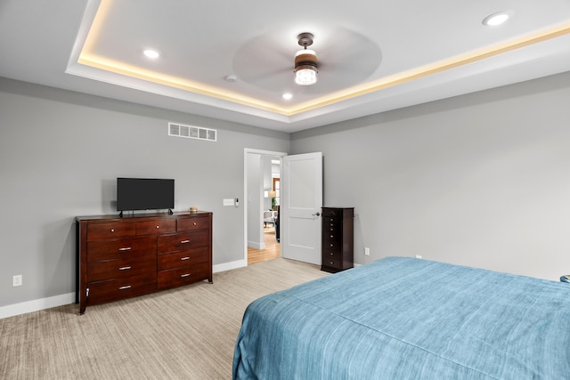 bedroom featuring visible vents, recessed lighting, a raised ceiling, and baseboards