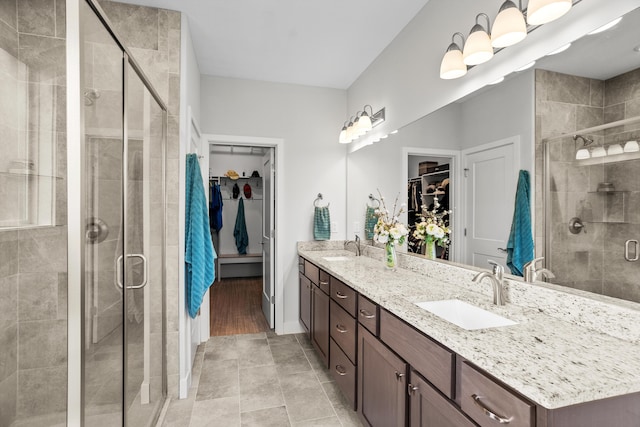 bathroom featuring a sink and a shower stall