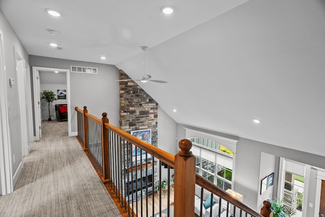 hall featuring visible vents, recessed lighting, vaulted ceiling, and an upstairs landing