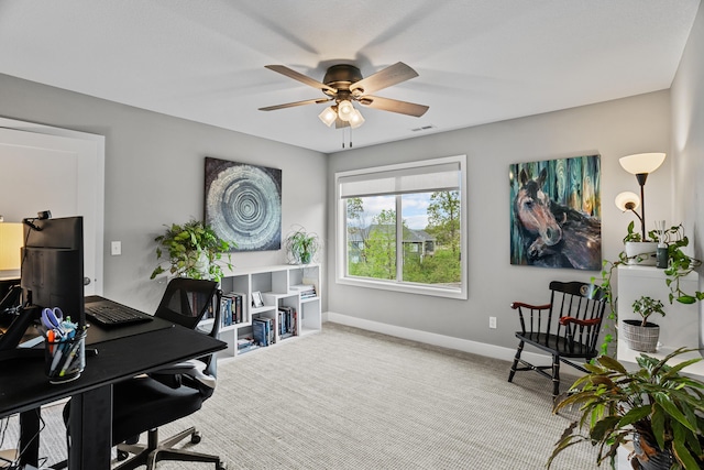 office space with baseboards, a ceiling fan, carpet floors, and visible vents