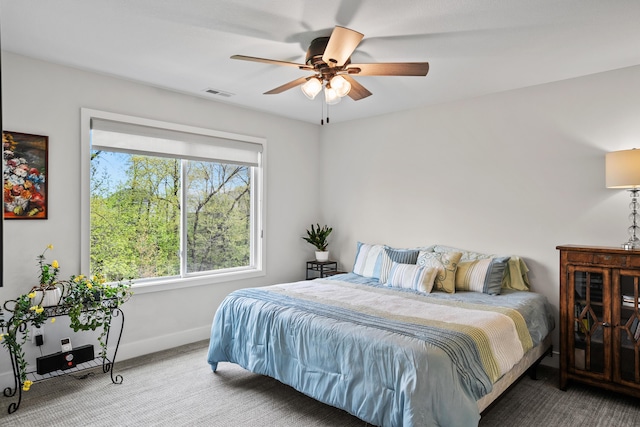 bedroom with baseboards, a ceiling fan, carpet, and visible vents