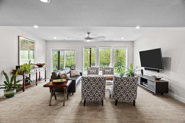 carpeted living room featuring baseboards, recessed lighting, and ceiling fan
