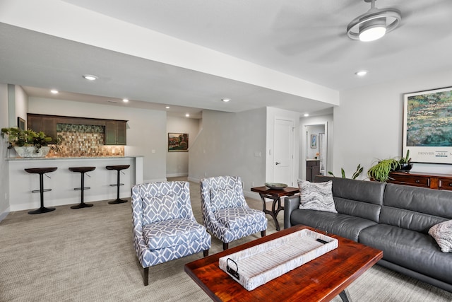 living area with recessed lighting, ceiling fan, bar area, and light carpet