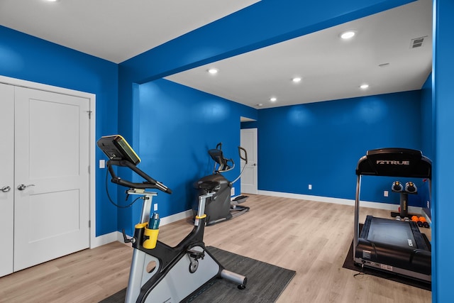workout room with baseboards, recessed lighting, wood finished floors, and visible vents