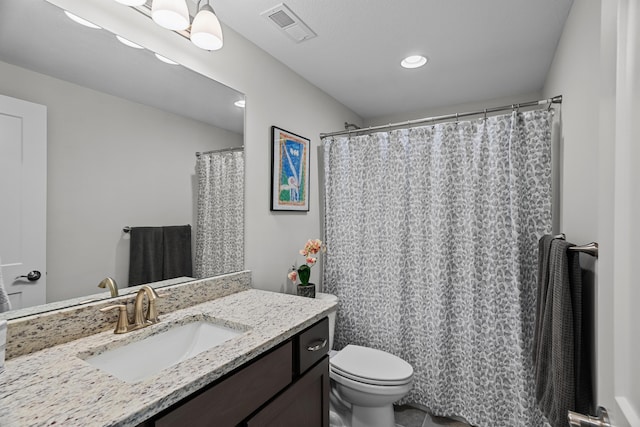 bathroom featuring visible vents, recessed lighting, toilet, and vanity
