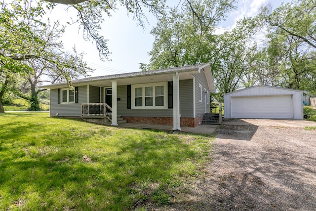 ranch-style home featuring a garage, an outbuilding, covered porch, and a front yard