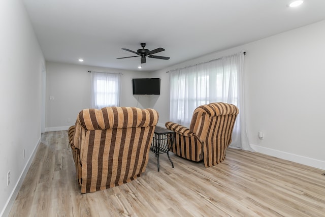 living area featuring recessed lighting, a ceiling fan, baseboards, and wood finished floors
