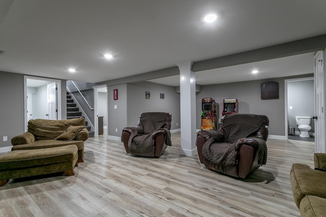 living room featuring recessed lighting, baseboards, stairs, and light wood-style flooring