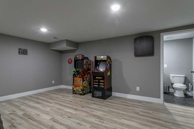 interior space with baseboards, recessed lighting, and wood finished floors