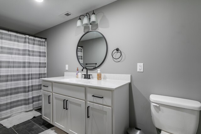 bathroom with toilet, visible vents, tile patterned flooring, and vanity